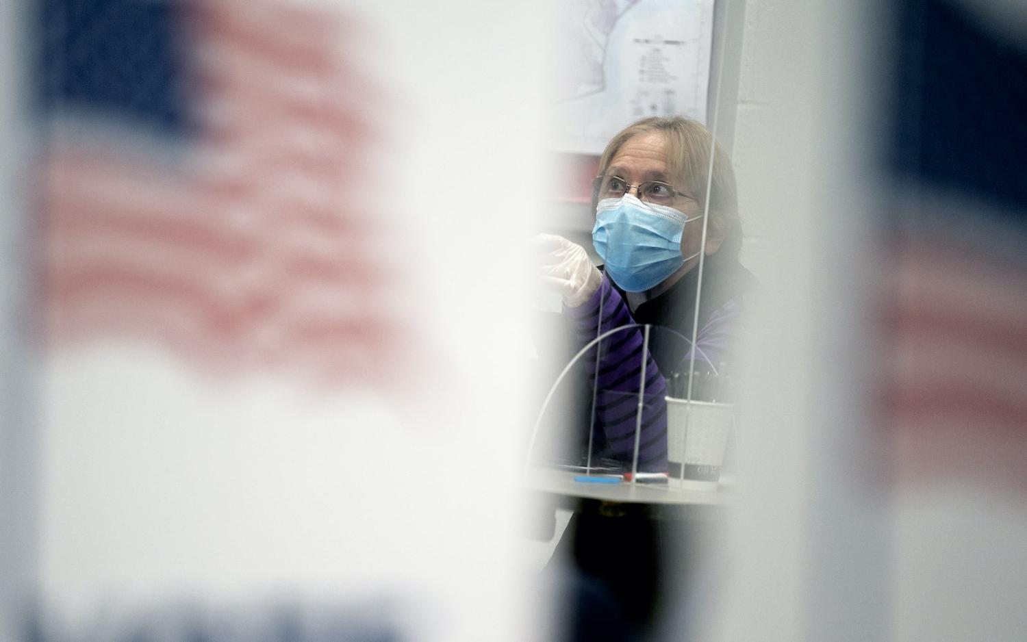 A poll worker at an early voting centre in Alexandria, Virginia, 31 October 2020 (Stefani Reynolds/Getty Images)